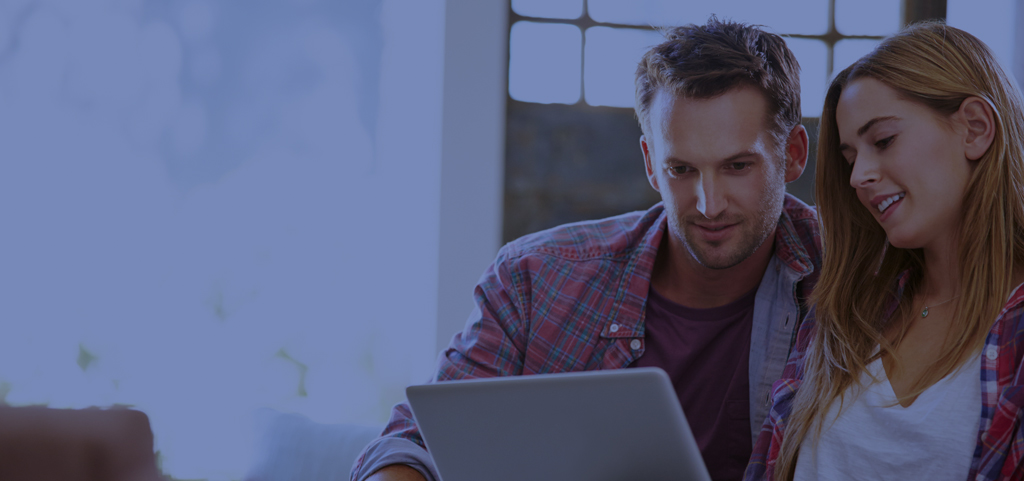 Stylistic photo of couple looking at laptop